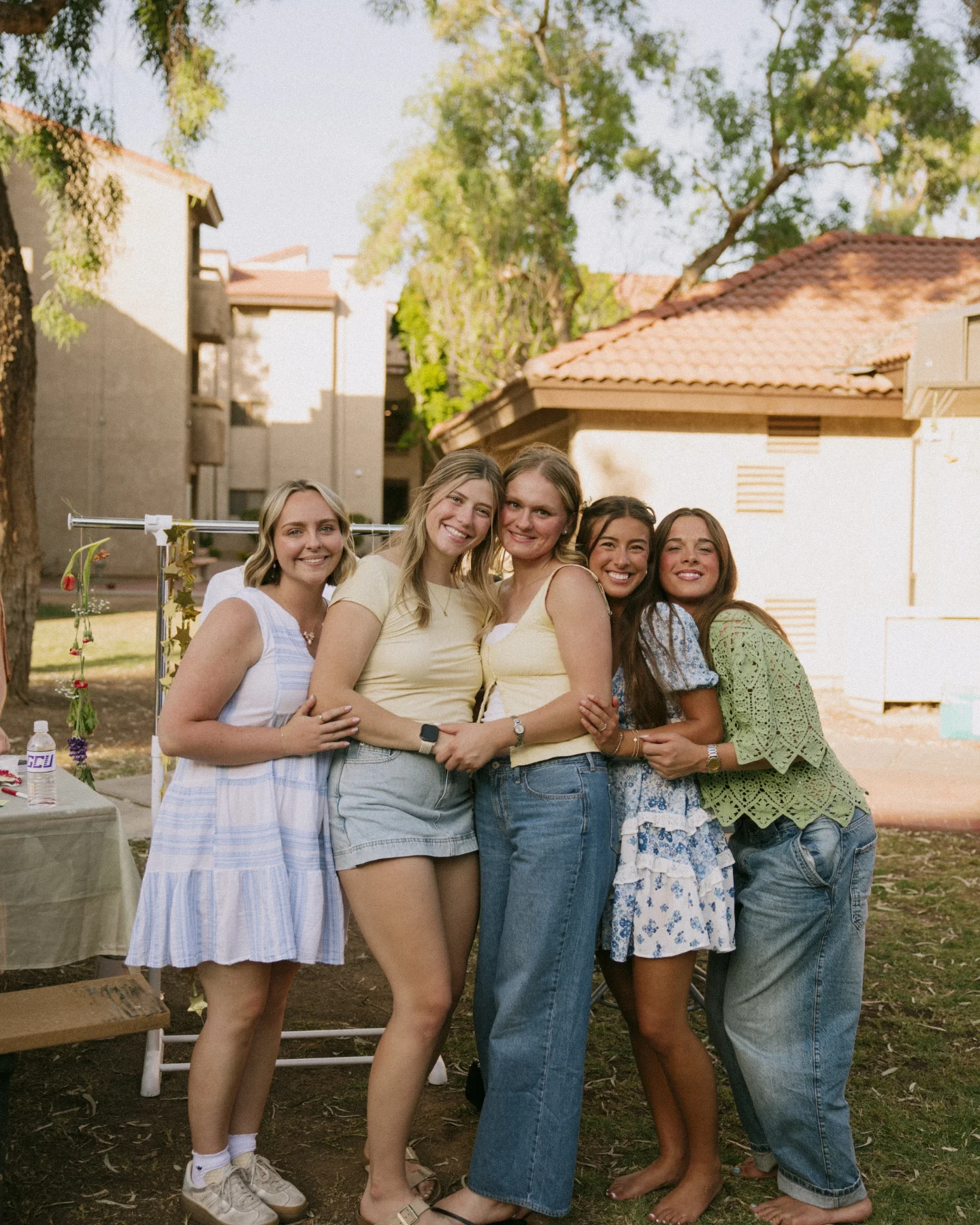 Five women smiling together at an outdoor Ezer gathering